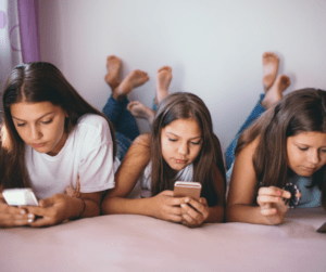 A group of young girls using social media