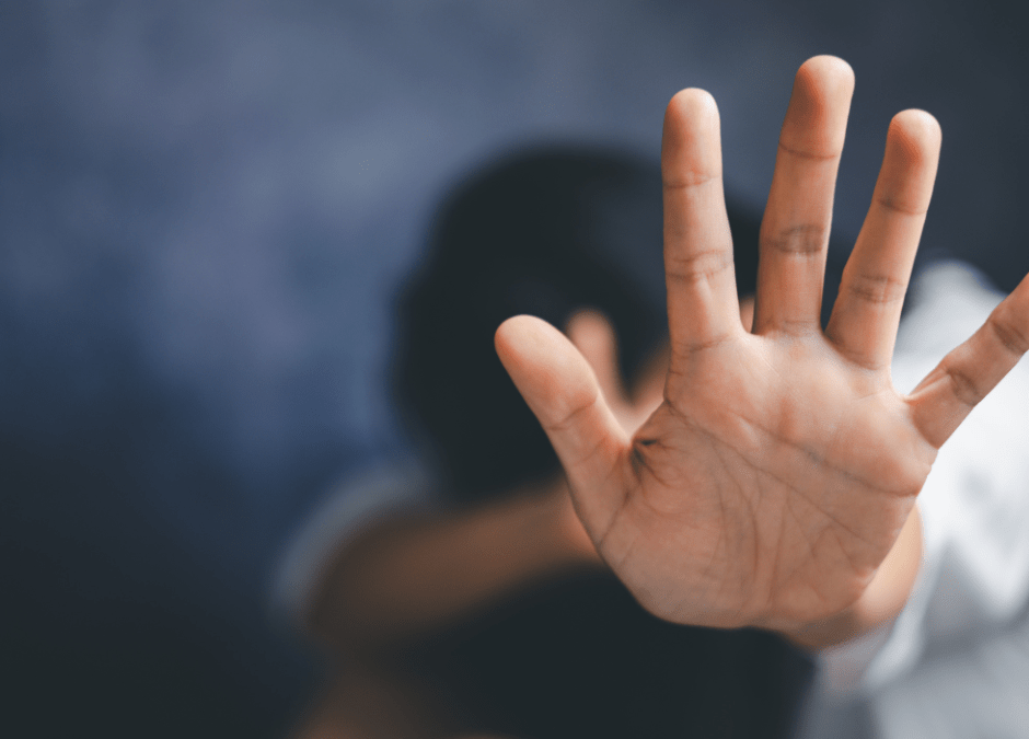 child holding up hand to stop family violence